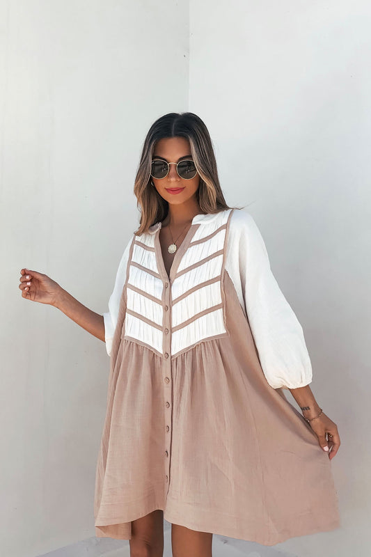 Woman in Cream Color Block Tunic Dress-FINAL SALE, sunglasses, and red lipstick stands against a plain light background.