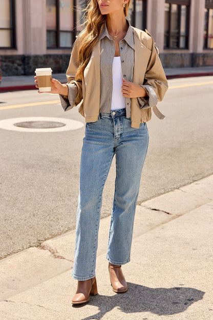 Woman in a Contrast Striped Shirt Jacket - Camel, white top, and jeans holds coffee—perfect chic layering for the city.