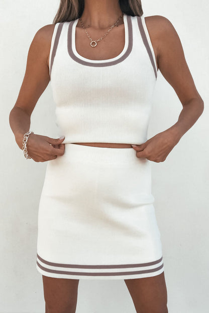 Woman in a Cream Contrast Trim Tank Top, styled sporty with brown accents, poses against a plain white background.