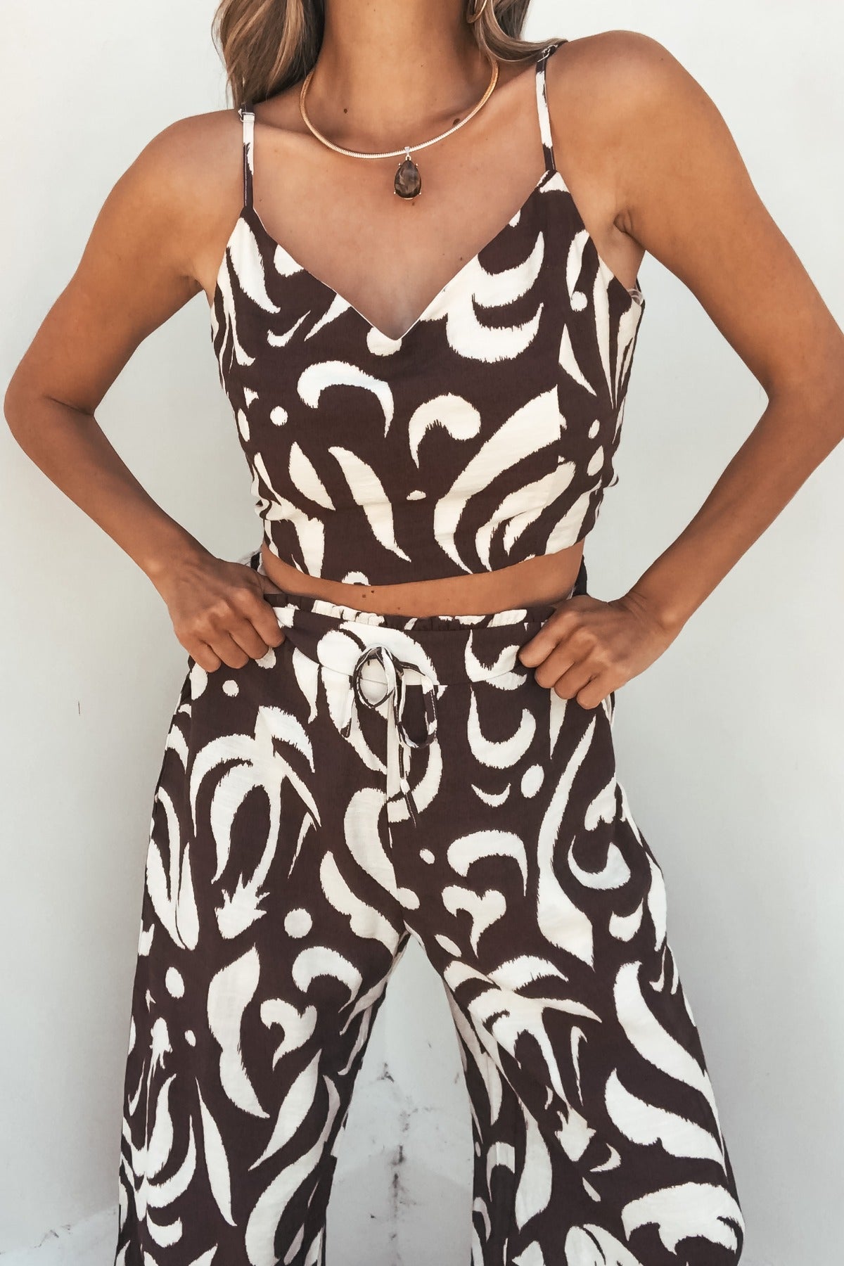 Model wears the Eda Print Cami Tank and Pants Set in brown, featuring wide leg pants. FINAL SALE.