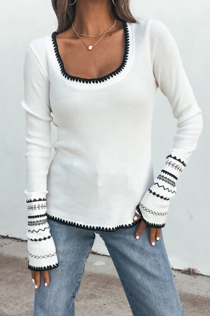 Woman wearing the white Free People Aspen Thermal Top (pre-order), styled with light blue jeans, standing against a plain background.