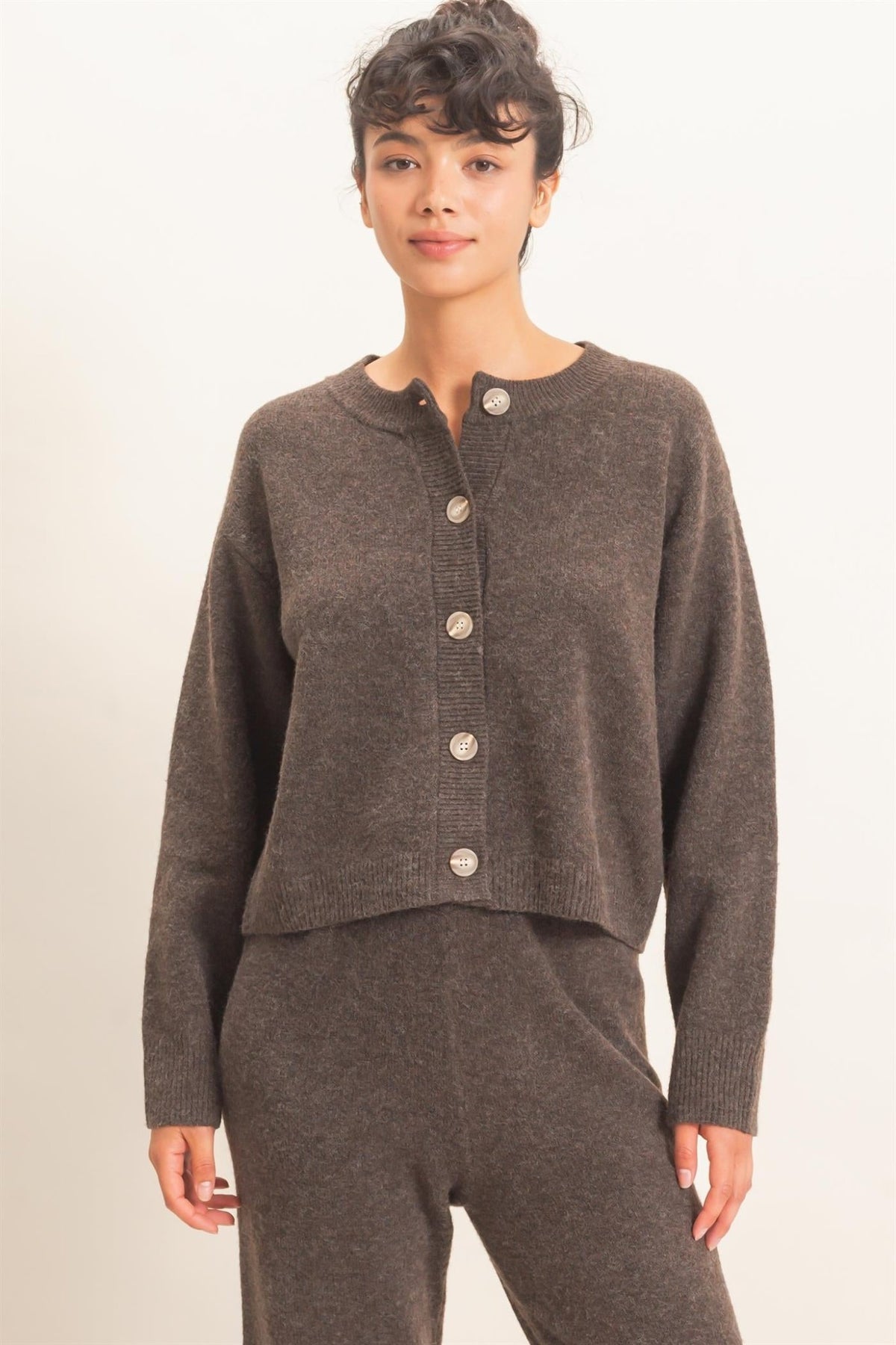 A woman wearing a HYFVE DZ26E639 DARK BROWN BUTTON UP CARDIGAN and matching pants.