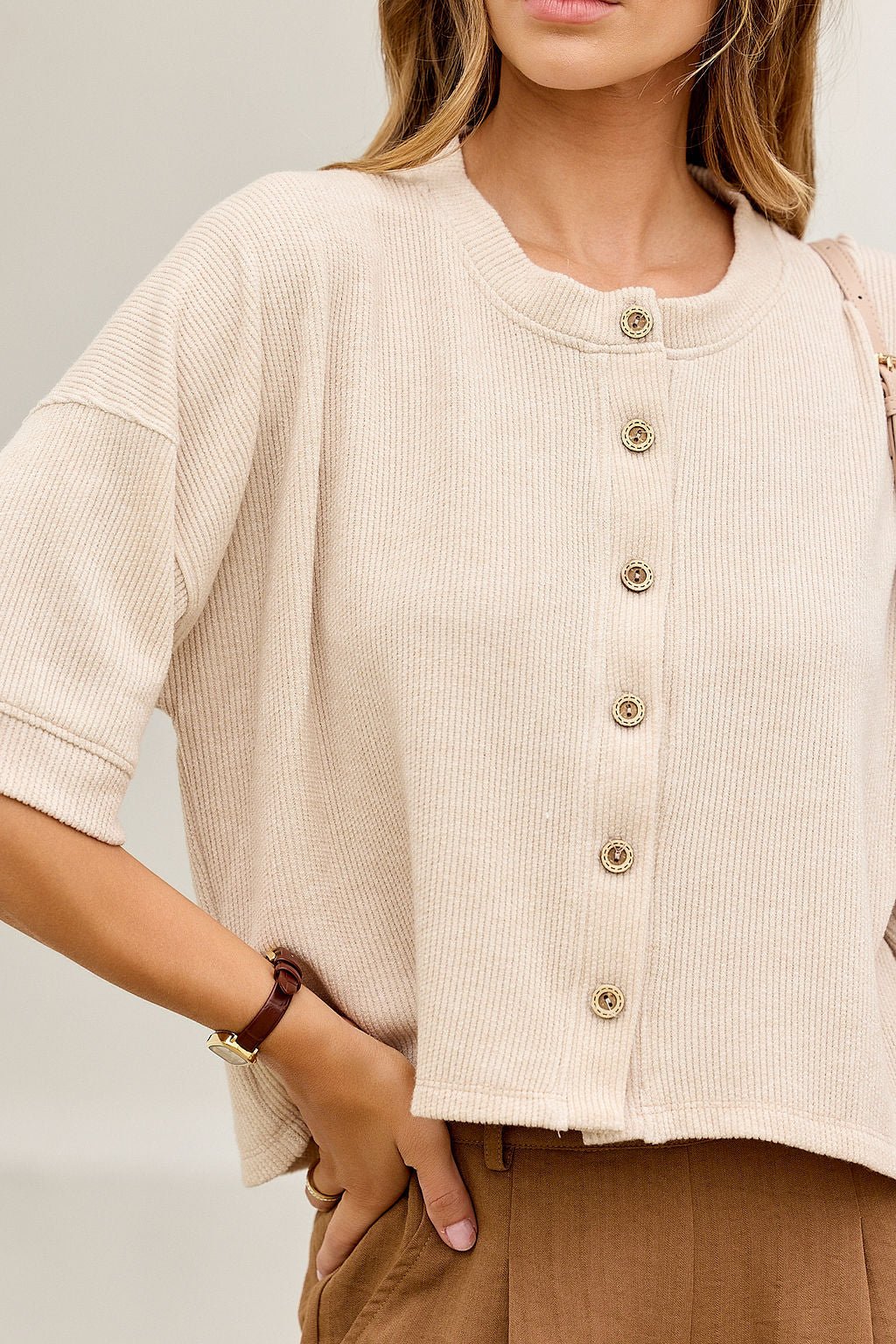 Woman in the Monday Morning Button Down Top - Oatmeal-FINAL SALE, with brown pants and a watch.