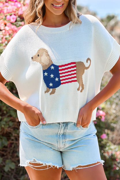 She wears the Patriotic Pup Knit Sweater - Cream with light denim shorts for a fun, casual look.