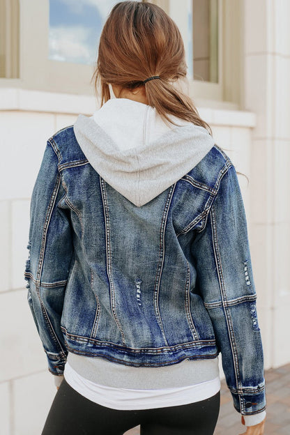 Woman in a Denim Jacket with Hoodie: Medium Wash, black leggings, hair in low ponytail—a versatile wardrobe look.