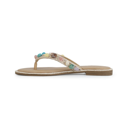 The Vintage Havana Sandy Beige Gemstone Flip Flops feature colorful gems on the thong strap—shown in a side view.